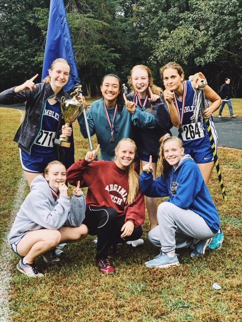 The girls varsity team poses with their medals.