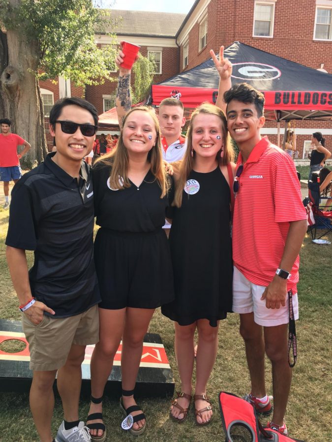Freshman Thanh Nham poses with a group of friends at a party.