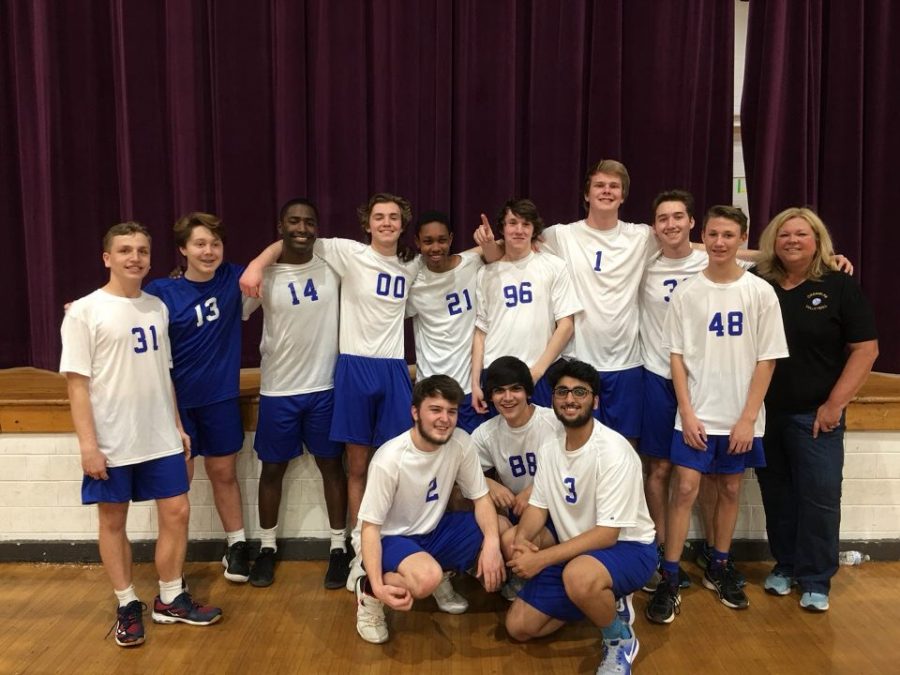 The boys' volleyball team poses for a photo.