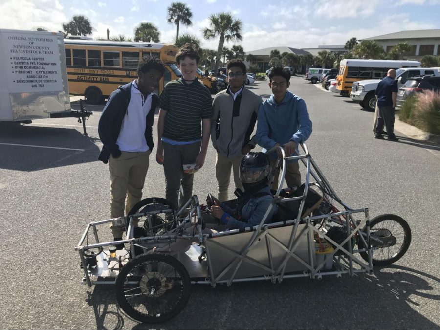 TSA members pose with the car they built for the Electrathon competition.