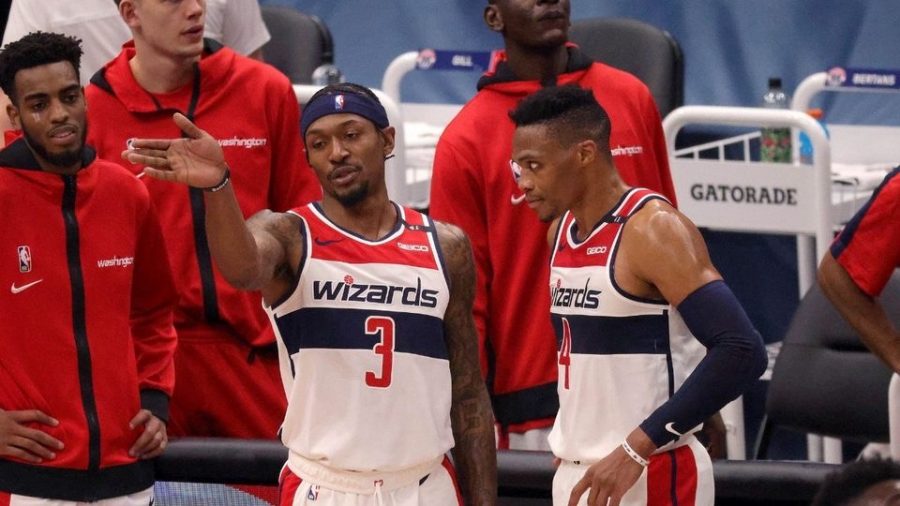 Bradley Beal and Russell Westbrook discuss the game plan during the stoppage of play.