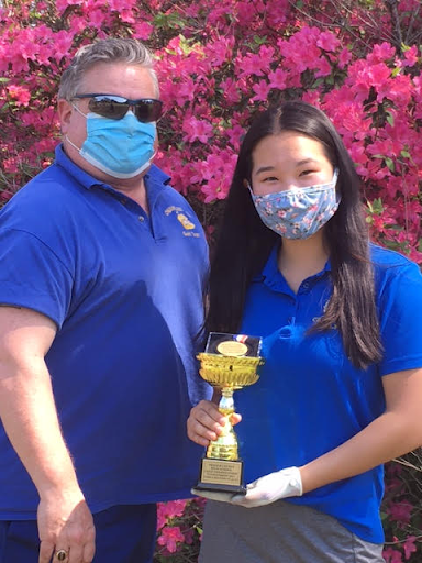 Golf coach Kurt Koeplin poses with Olivia Li, who finished second overall in individual score at the county championships