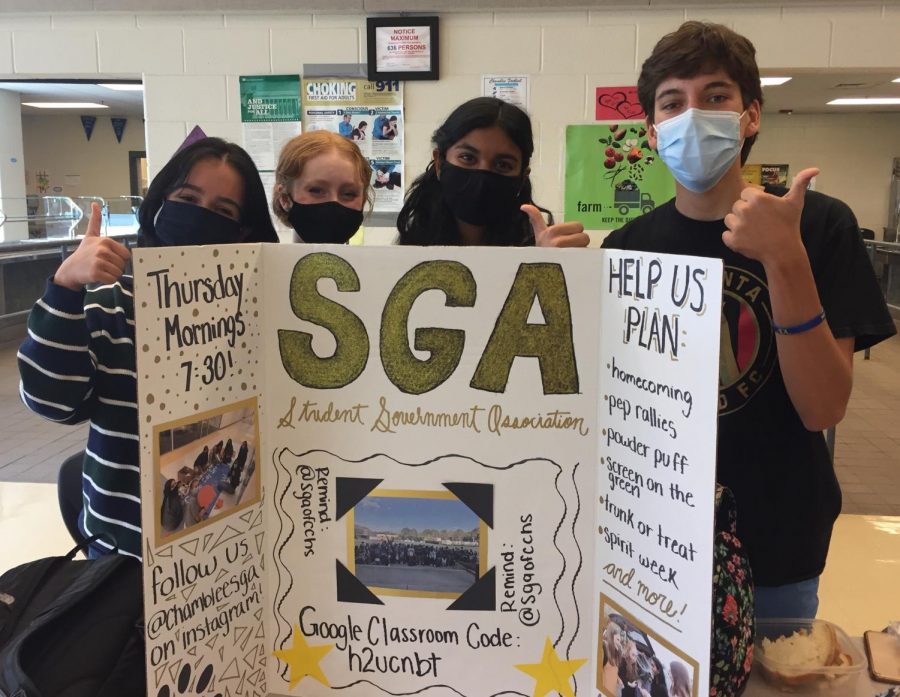 Student Government Association members pose with their clubs board.
