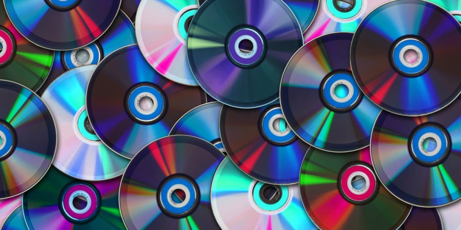 A pile of multicolor CDs lie across a platform.