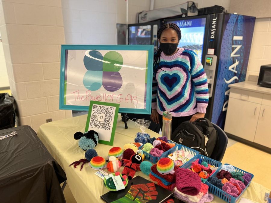 Business owner Kaylee Powell (22) shows off her business at the Black-owned business event in the cafeteria.