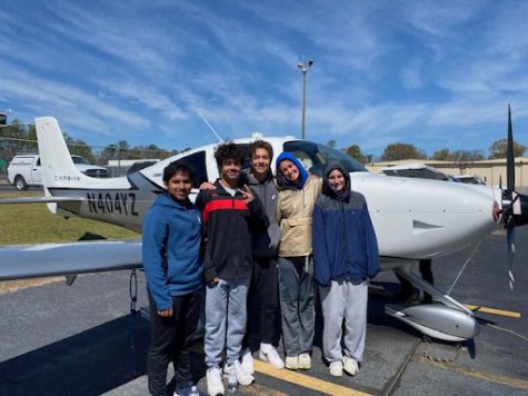 Aviation club members pose in front of an airplane at Peachtree DeKalb Airport. From left to right: Pyusih Roy (‘24), Travis Conner (24), Olivia Bell (24), and Sadie Schroeder (24).