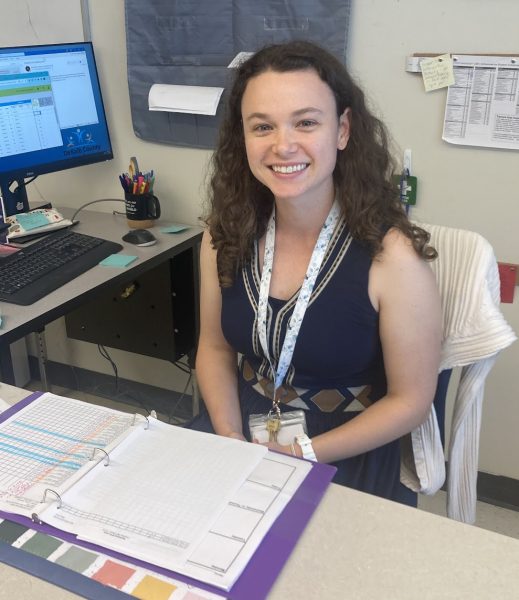 Towner having fun at her desk as she plans science classes. Photo by Miles Forshay