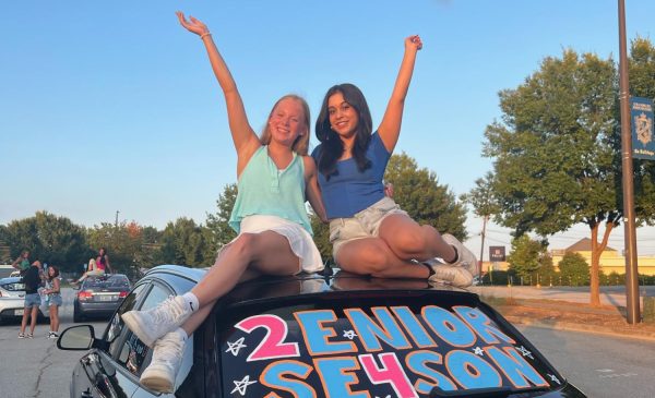 Chamblee seniors Lilly Smith and Shruti Nainwal pose on top of their newly decorated car.
