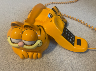 My Garfield telephone with the receiver laying against it. Photo by Juliet Gonzalez