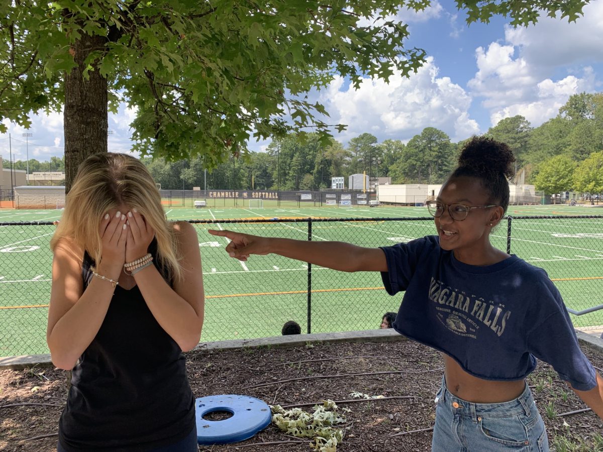 Julia Cashin (‘26) and Zoe McNeil (‘26) pretend to be in a political standoff.
Photo  by Finley Malone