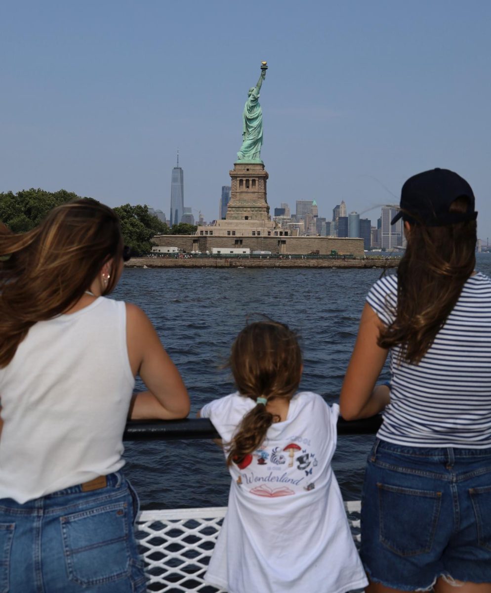 Anna Kate Flood (‘26) and her sisters on a ferryboat after seeing the Statue of Liberty. Photo courtesy of Anna Kate Flood.