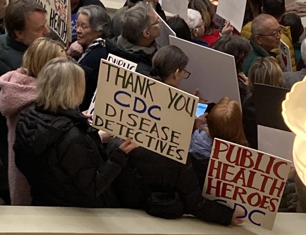 Supporters of the CDC hold up signs, while standing on the Capitol’s steps. Photos Courtesy of Jackson Lee.
