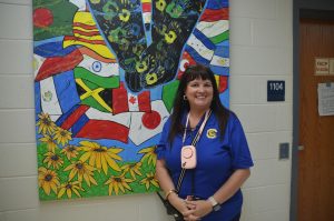 Dr. Conner posing in front of a bulletin board. Photo by Michael Bryant.