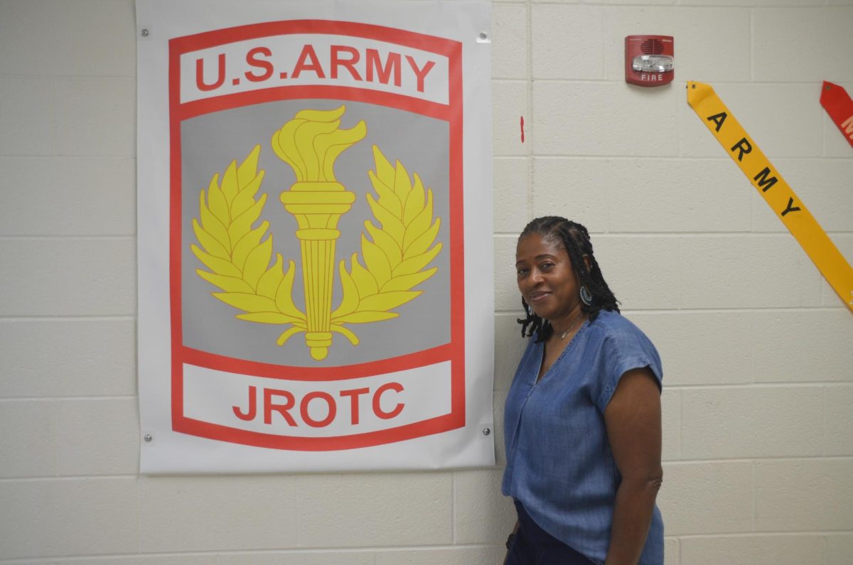 Colonel Dunklin pictured by the JROTC sign. Photo by Michael Bryant.