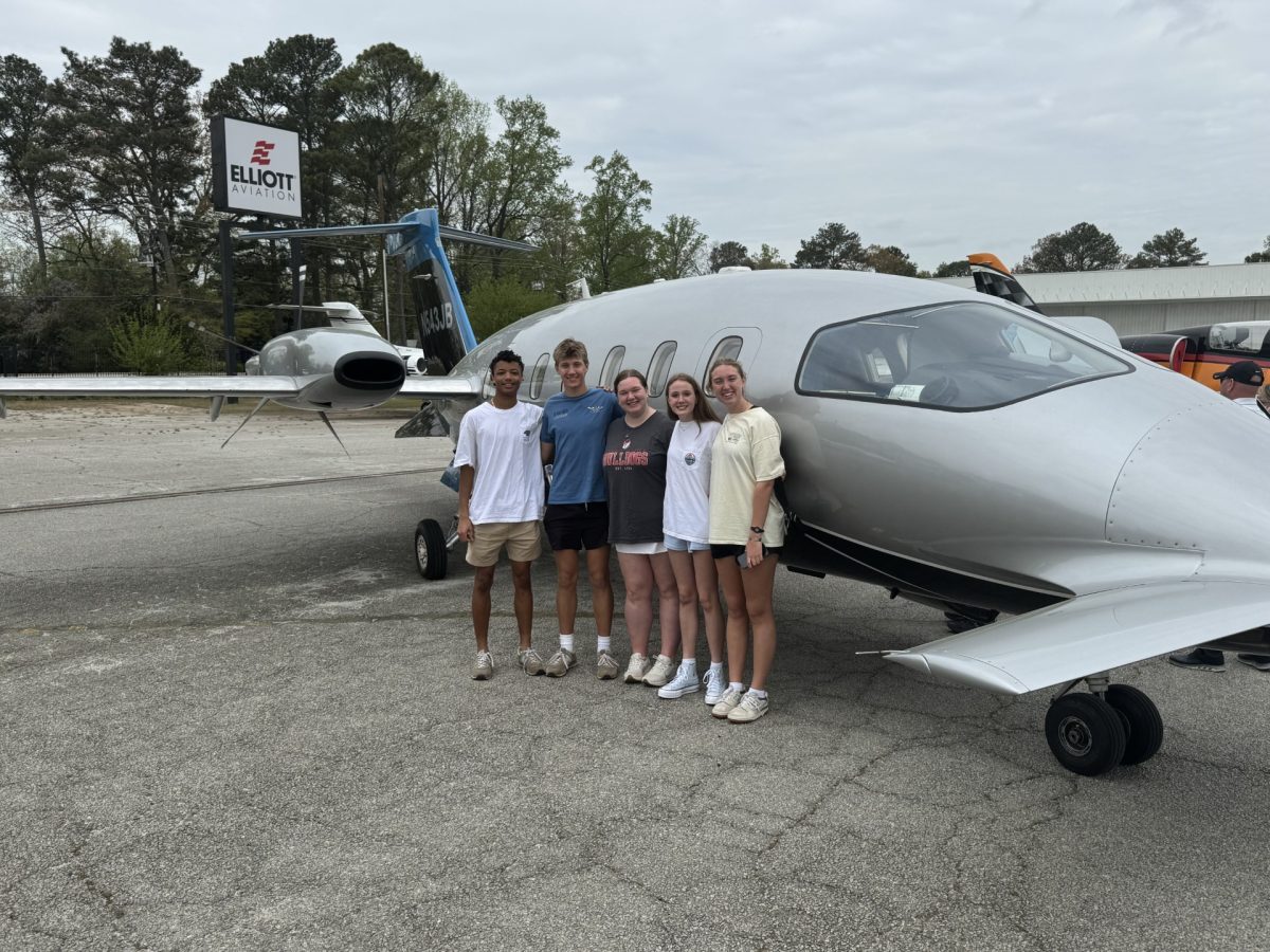 Jonas Maender (‘26), Duke Nichols (‘26), Mallory Williams (‘26), Camille Avery (‘27), and Grace Nichols in front of a plane. Photo courtesy of Mallory Williams (‘26).

