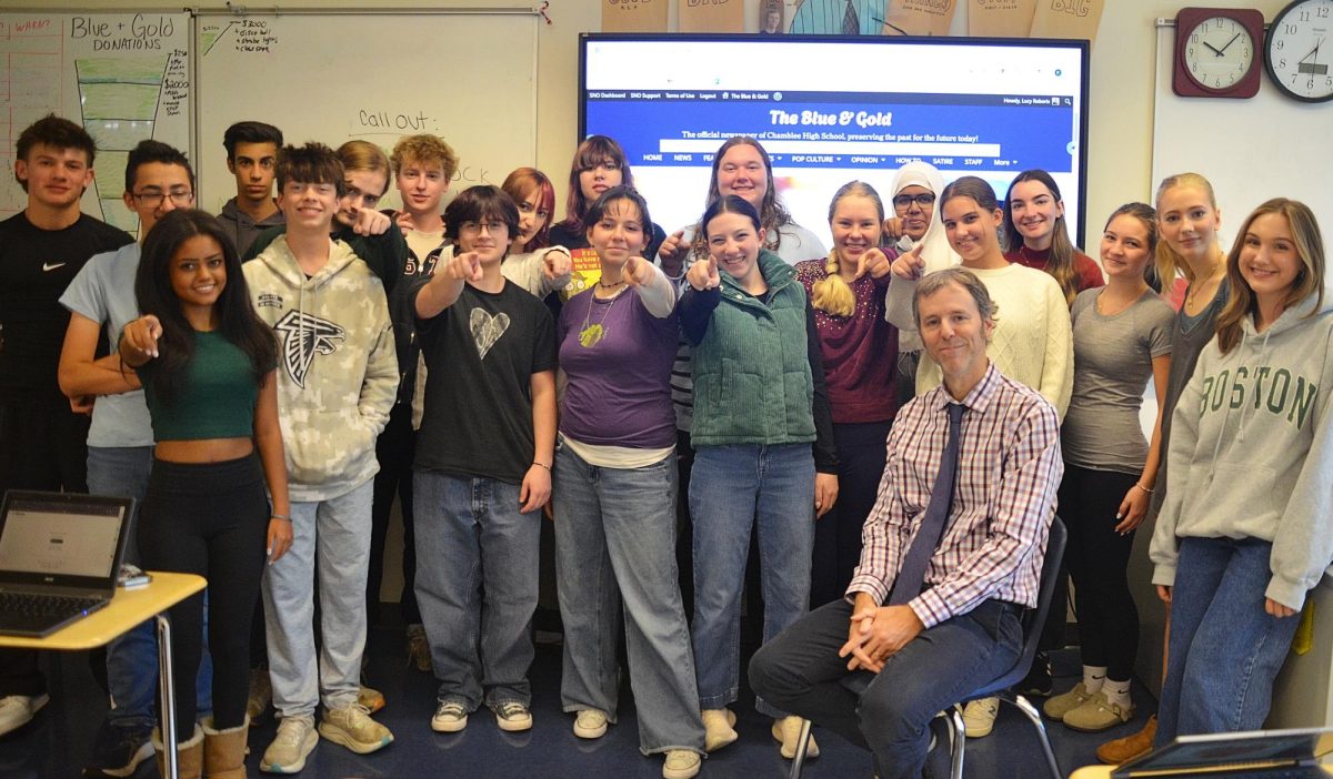 Blue and Gold staff members posing in front of their website. Photo by Michael Bryant.
