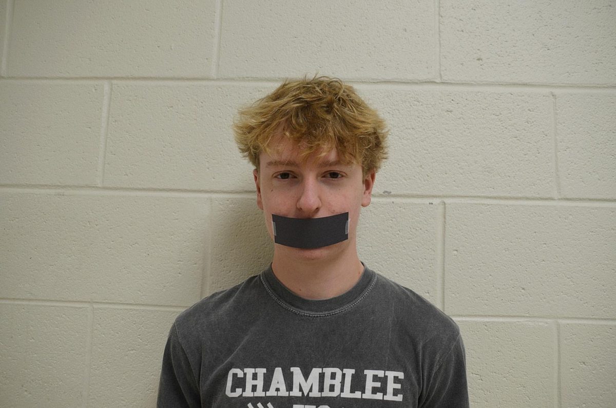 Patrick Shaw ('26) posing with tap over his mouth. Photo by Michael Bryant.