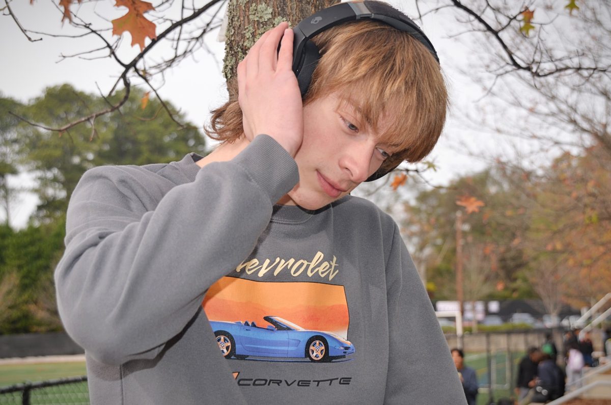 Wyatt Wright ('26) posing listening to music. Photo by Michael Bryant.