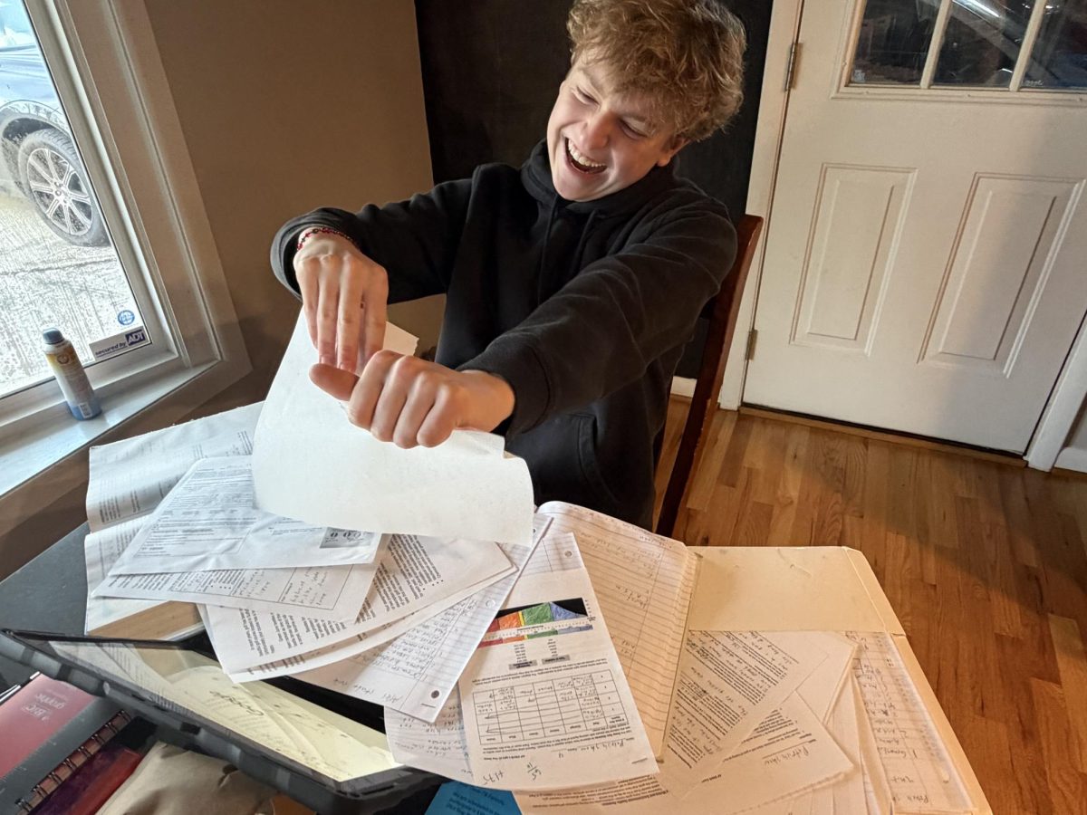 Student ripping up his work due to senioritis. Photo by Patrick Shaw.
