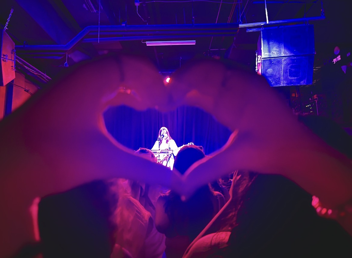 The author's hands framing Solya in a heart during Solya's show in Atlanta on September 15th, 2024. Photo by Vera Kurbatova ('27).