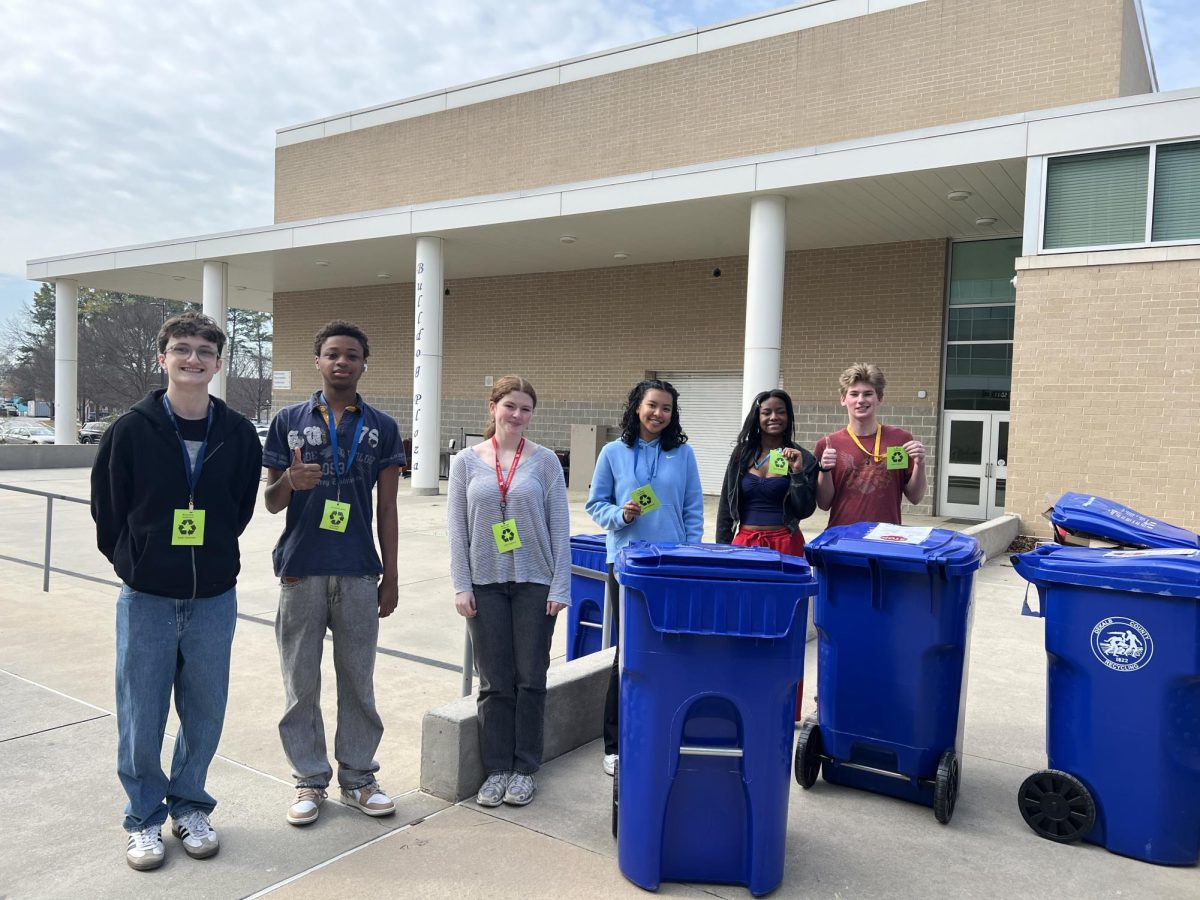 (Left to right) Jackson Warren (‘26), Isaac Agbossoumonde (‘26), Vivian Shoemaker (‘28), Makayla Huang (‘28), Meah Griffin (‘27), and Mack Williams (‘27) with recycling cans in Bulldog Plaza. Photo by Noa Zilber.