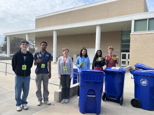 (Left to right) Jackson Warren (‘26), Isaac Agbossoumonde (‘26), Vivian Shoemaker (‘28), Makayla Huang (‘28), Meah Griffin (‘27), and Mack Williams (‘27) with recycling cans in Bulldog Plaza. Photo by Noa Zilber.